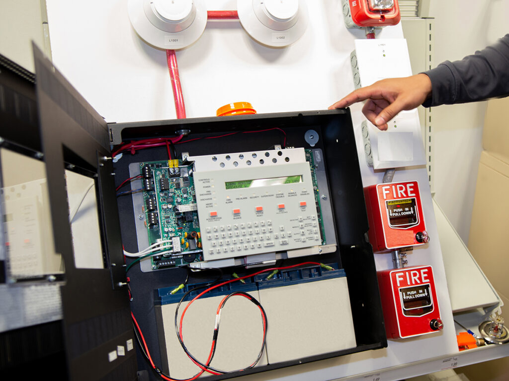 Fire alarm systems attached to a white wall used for training