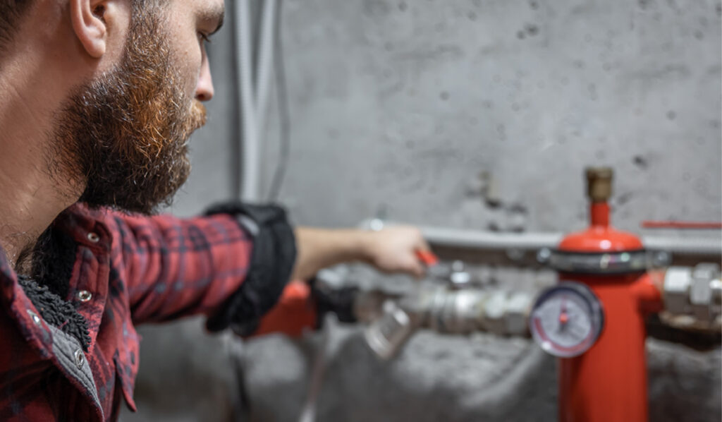 Man checking pressure meter