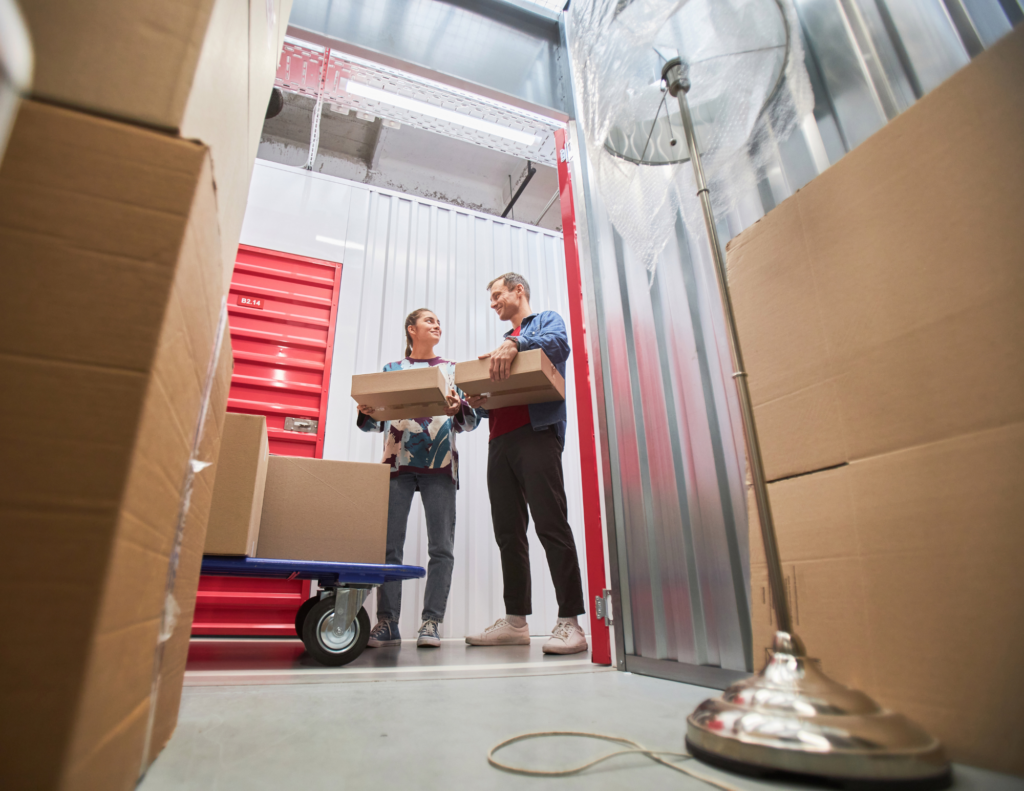 two people moving items in self storage